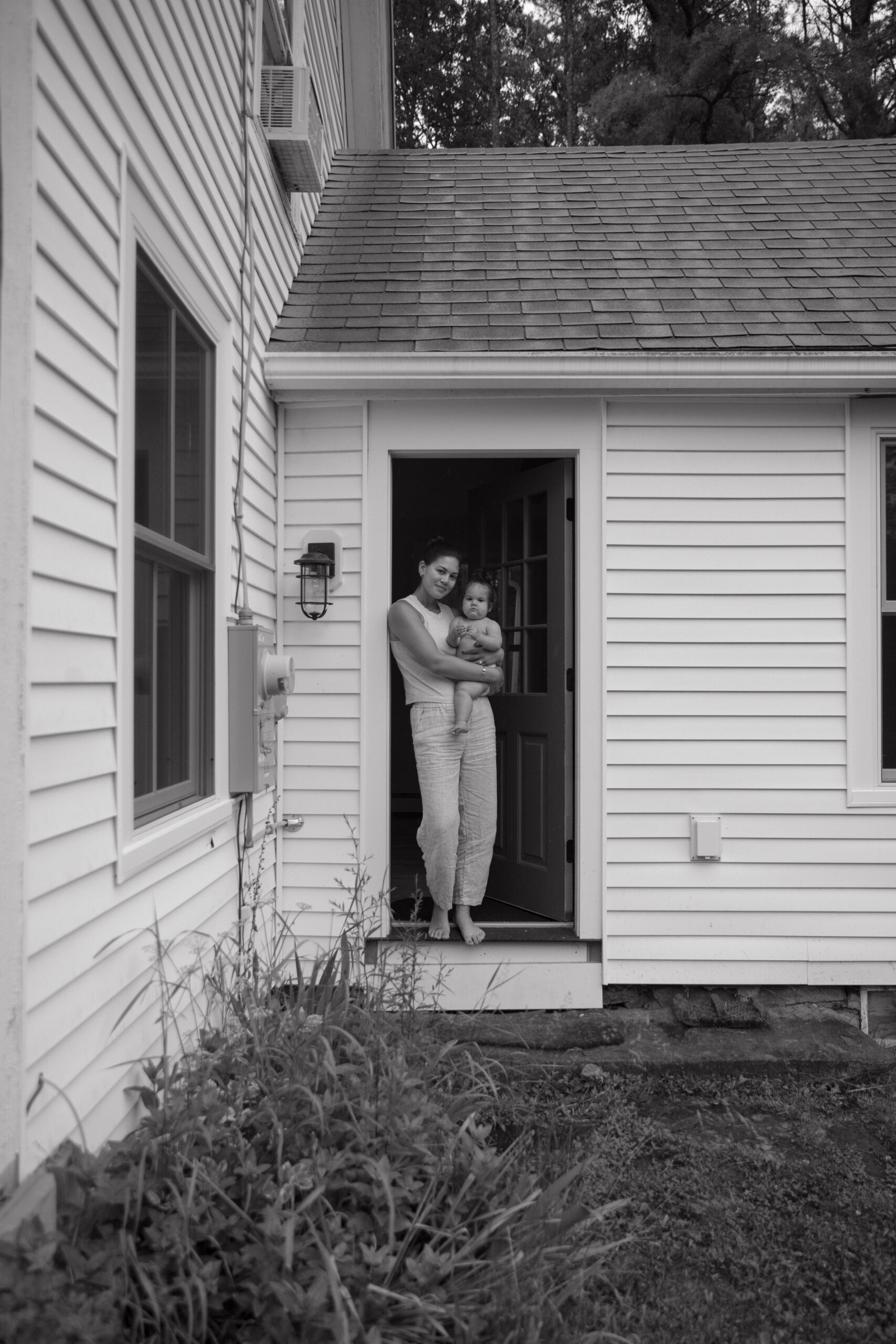 Documentary style family photography with an emphasis on motherhood from an in-home photoshoot in Southport, Maine.